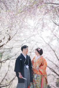桜の東山動植物園で和装前撮りロケーション　桜のアーチの下で見つめ合ってほほ笑む新郎新婦