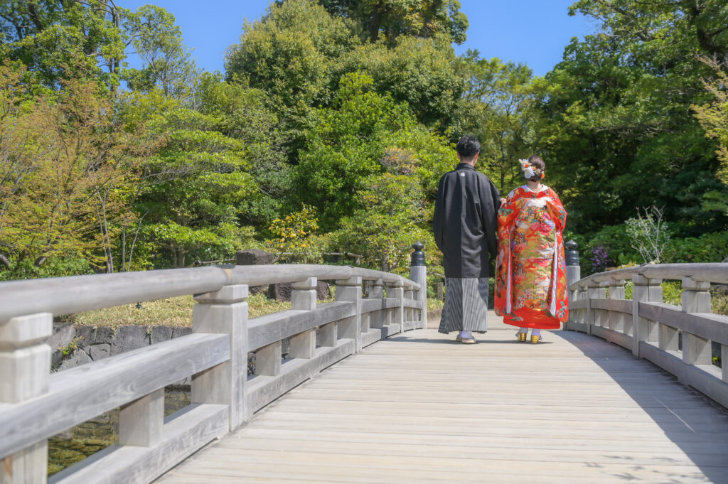 徳川園の橋の上を歩く和装姿の新郎新婦の後ろ姿